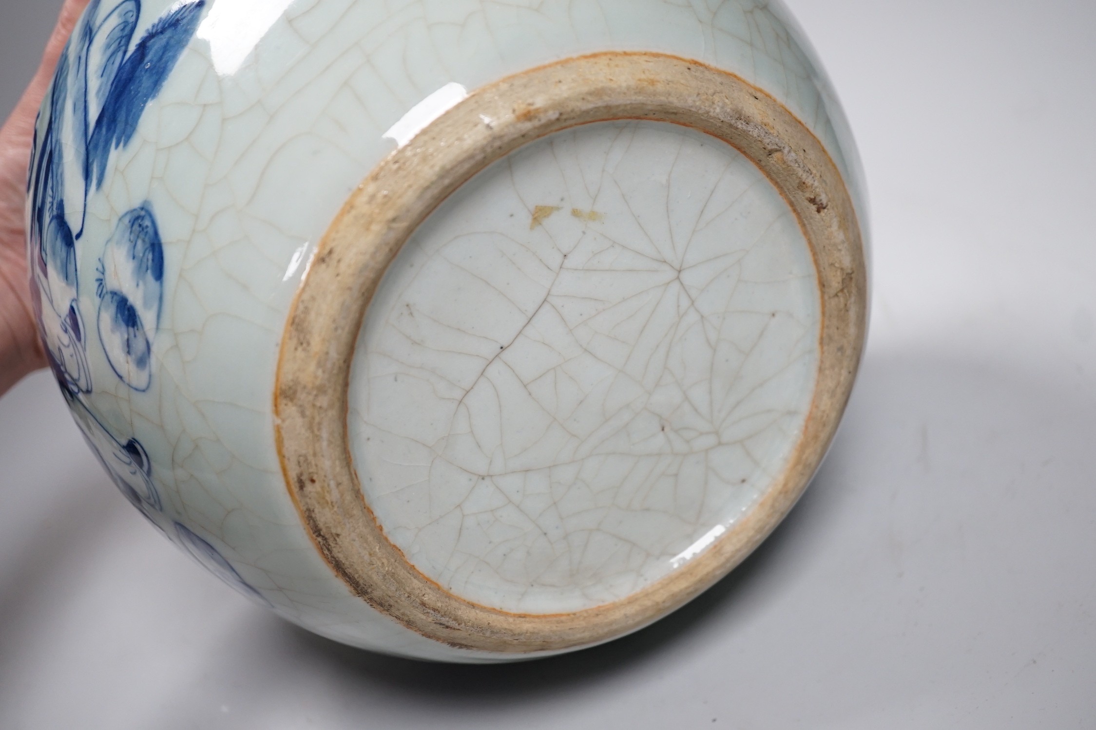 A Chinese underglaze blue and slip decorated celadon crackle glazed vase and associated cover, late Qing dynasty, 21cms high